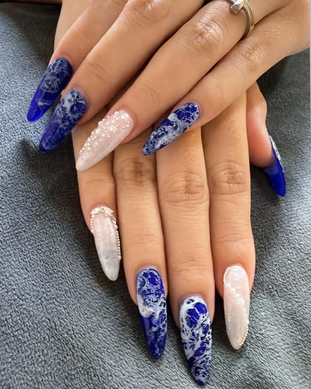 Blue and white marble nail art with pearl beads at Nail & Co. Hougang